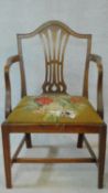 A Georgian mahogany framed armchair with pierced shaped splat above tapestry upholstered drop in