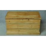 A late 19th century pine chest with hinged lidded top on plinth base. H.53 W.96 D.59cm