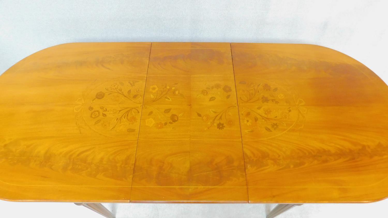 A Continental flame mahogany extending dining table with brass mounts and central floral inlay - Image 2 of 6