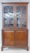 A 19th century mahogany and satinwood strung library bookcase with astragal glazed doors above