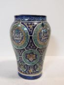 A 20th century Islamic Isnik style pottery vase, probably Moroccan, the baluster body painted with