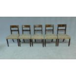 A set of five late Georgian mahogany and satinwood inlaid dining chairs in damask stuffover seats on