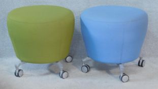 A pair of vintage style Orangebox stools in viridescent and sky blue upholstery on metal supports.