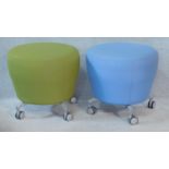 A pair of vintage style Orangebox stools in viridescent and sky blue upholstery on metal supports.