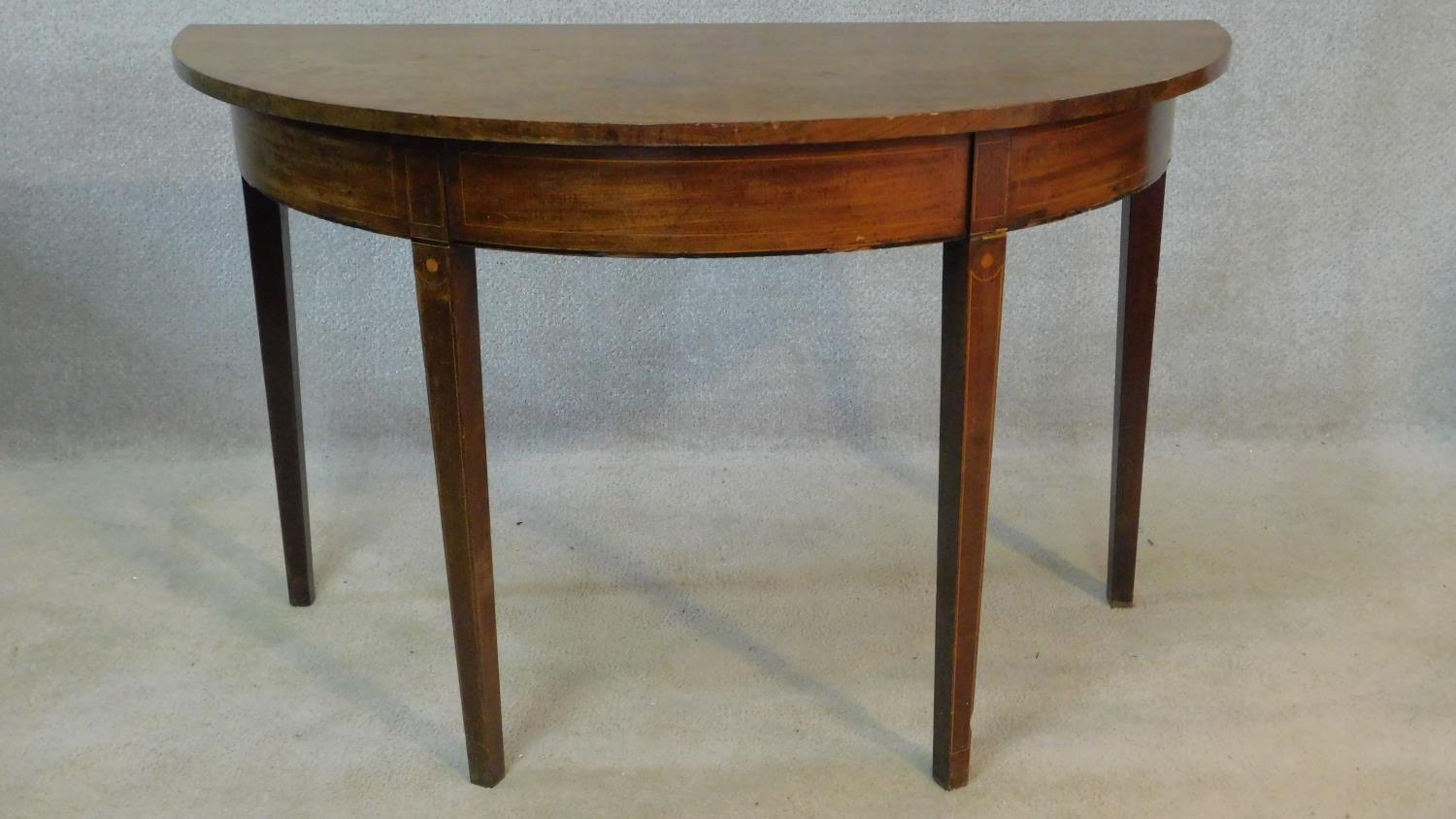 A Georgian mahogany and satinwood inlaid demi lune console table on square tapering legs. H.73 W.122