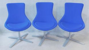 Three Orangebox swivel tub chairs in a textile upholstery fitted with seat cushions on metal