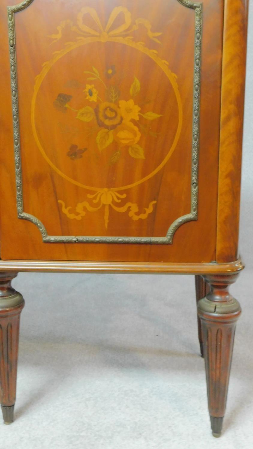 A Continental flame mahogany four door sideboard with floral inlaid panels on fluted tapering - Image 3 of 4
