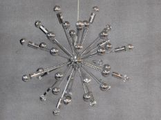 A chromium sputnik style ceiling chandelier, multiple arms of varying lengths expanding from a