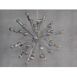 A chromium sputnik style ceiling chandelier, multiple arms of varying lengths expanding from a