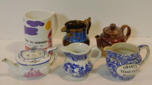A collection of six antique and vintage jugs and tea pots. Inlcuding A Royal Doulton Lambeth Harvest