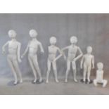 A miscellaneous collection of six children mannequins with swing arms. Three standing on bases. H.