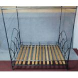 A iron framed tester bedstead with arched Gothic style head and foot. to take a 5 ft mattress.