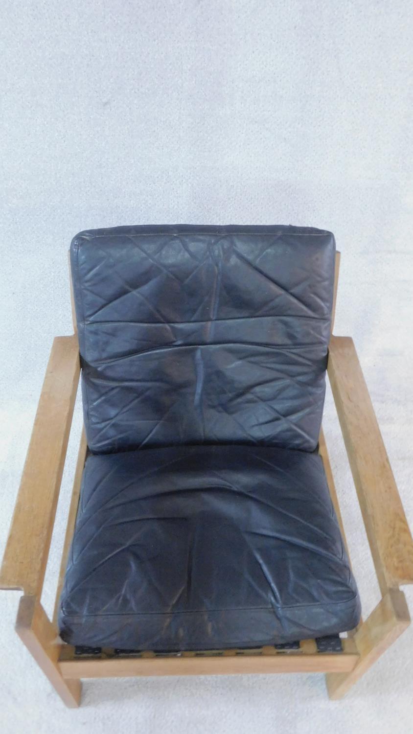 A mid century vintage teak framed armchair with black leather seat and back cushions. 77x70cm - Image 2 of 3
