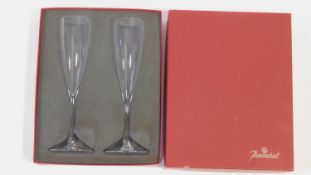 A pair of boxed Baccarat crystal champagne flutes. Signed to the base. H.23cm