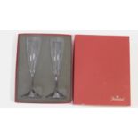 A pair of boxed Baccarat crystal champagne flutes. Signed to the base. H.23cm