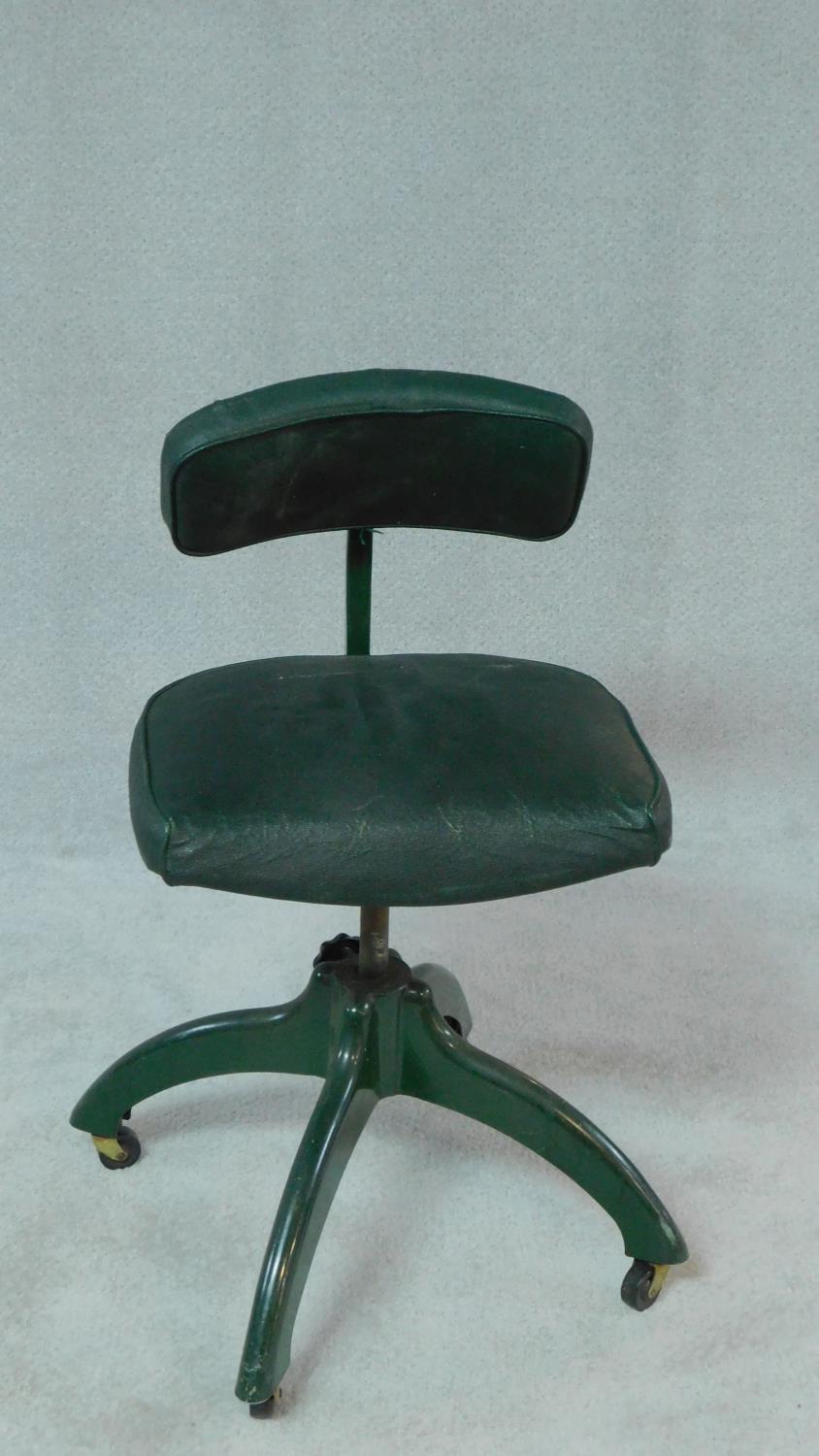 A vintage revolving office desk chair on cast iron base with casters. H.83cm