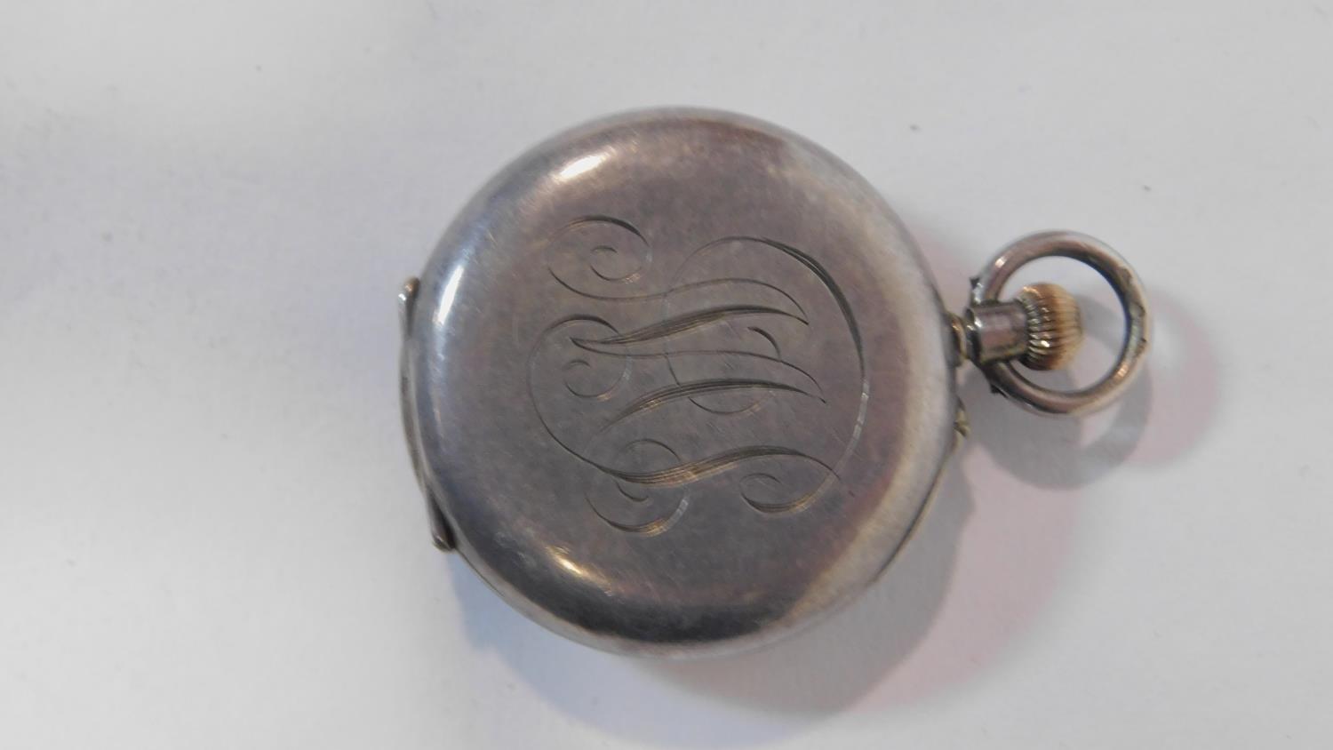 An antique small silver half hunter fob watch. Hallmarked with swiss hallmarks, 935. White enamel - Image 2 of 4