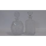 Two crystal decanters one very heavy lead crystal with a geometric and star cut design with matt and