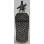 A mid century vintage chromium and mesh covered soda syphon. H.36cm