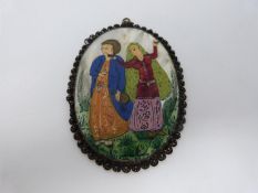 A 20th century Persian white metal framed pendant miniature painting on mother of pearl of a young
