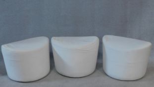 A set of three low stools in calico upholstery. H.40 W.58 D.45cm