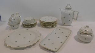 A late 19th century porcelain coffee service and tray with gilded highlighted rims and allover