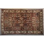 A Persian Bakhtiar carpet with stylised floral panels repeating across the field within stylised