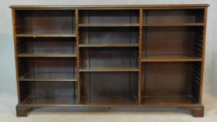 An early 20th century mahogany dwarf library bookcase with three sections of adjustable shelves on