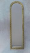 An arched framed dressing mirror with gilt floral swag decoration. 130x30cm