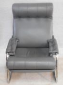 A vintage reclining armchair on chrome base in charcoal buttoned leather upholstery. H.82 W.65