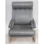 A vintage reclining armchair on chrome base in charcoal buttoned leather upholstery. H.82 W.65