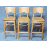 A set of three contemporary beech high chairs. H.110cm