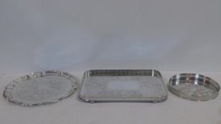 A rounded rectangular floral etched silver plated tray with pierced gallery, a similar circular tray