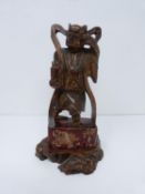 A Qing dynasty gilt red lacquer carved wooden guardian figure on square base. H22cm