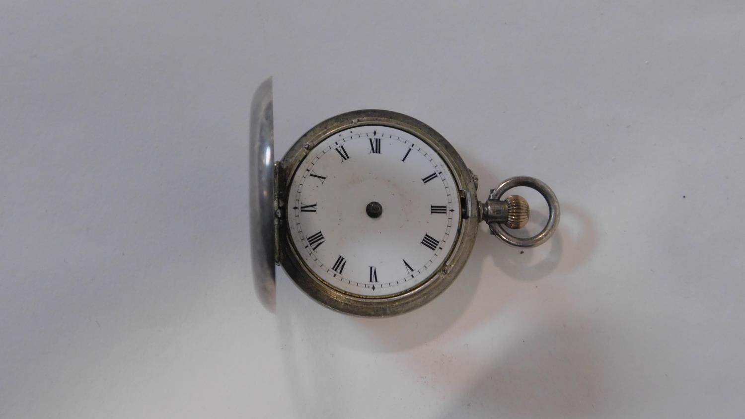 An antique small silver half hunter fob watch. Hallmarked with swiss hallmarks, 935. White enamel - Image 3 of 4