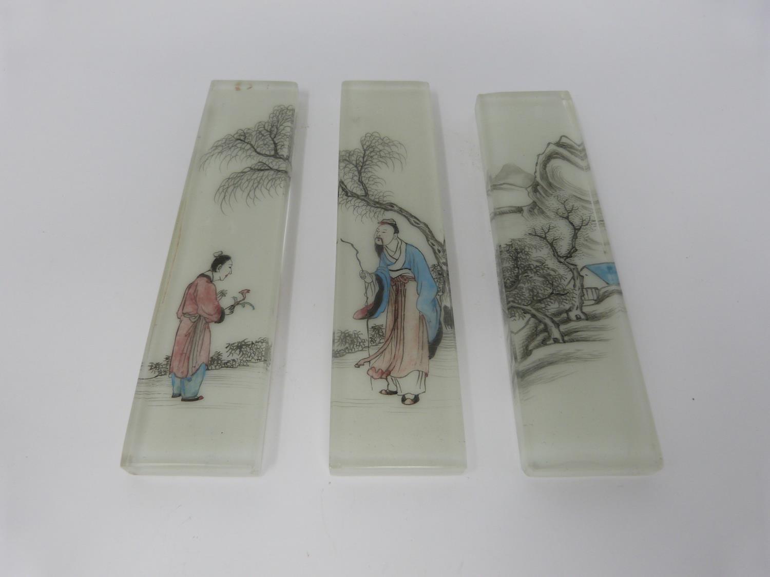 Three Qing dynasty Chinese reverse painted, opaque white glass backed bricks/scroll weights.