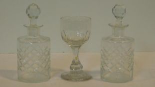 A Georgian blown glass cordial glass along with a pair of antique cut crystal bottles with