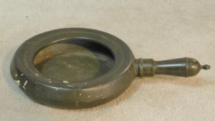A 19th century pewter bedpan with makers rose and crown stamp to the base, London. 46x30cm