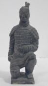 A Qin dynasty style terracotta kneeling archer figure. H.29cm