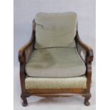 A mid century mahogany framed bergere armchair with squab cushions to seat and back. H.79 W.74 D.