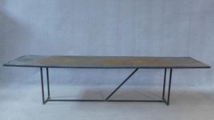 A contemporary metal topped industrial style coffee table on tubular metal base. H.58 W.247 D.60cm