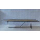 A contemporary metal topped industrial style coffee table on tubular metal base. H.58 W.247 D.60cm