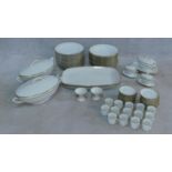 An extensive dinner service in white porcelain and gilt highlighted rims, marked Epiag,
