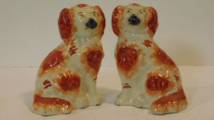 A pair of antique Staffordshire style dogs with hand painted detailing. H.19cm