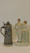 A 19th century Staffordshire flatback figure group and a lidded German stein. H.40cm