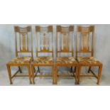 A set of four late 19th century carved oak dining chairs with Glasgow School motif to the back