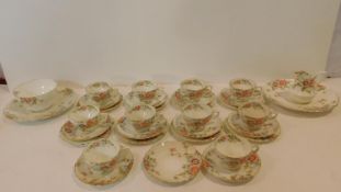 A ten person antique hand painted rose design tea set with hand painted numbers to the base.