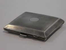 An Art Deco engine turned decorated silver cigarette case with gilded interior and circular