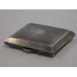 An Art Deco engine turned decorated silver cigarette case with gilded interior and circular