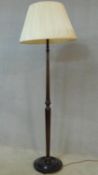 An early 20th century carved and turned mahogany standard lamp on circular base. H.178cm